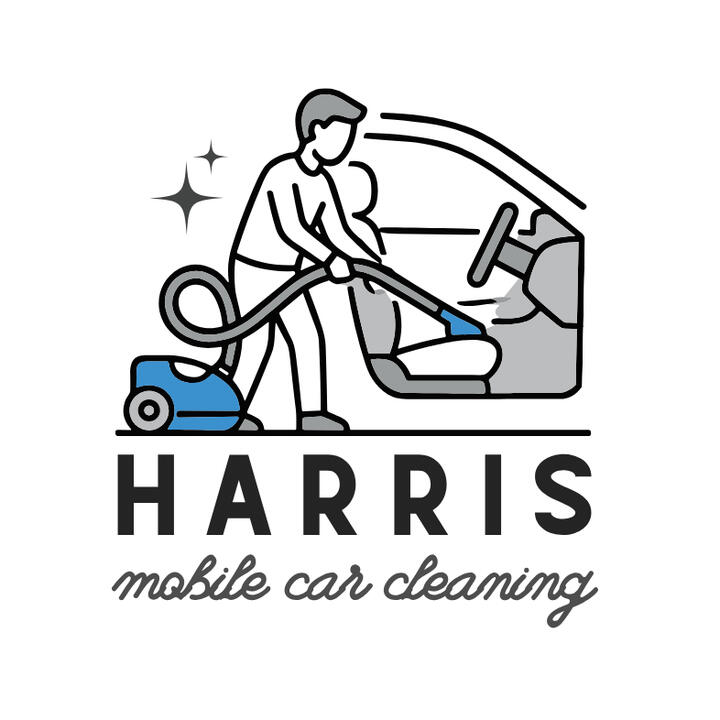 Harris Mobile Car Cleaning A man cleaning the interior of a car with a vacuum